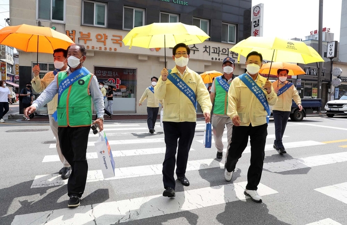 30일 양승조 충남지사가 홍성군 일원에서 홍성군자율방재단과 함께 ‘도민과 함께하는 양산 쓰기’ 거리 캠페인을 전개했다.